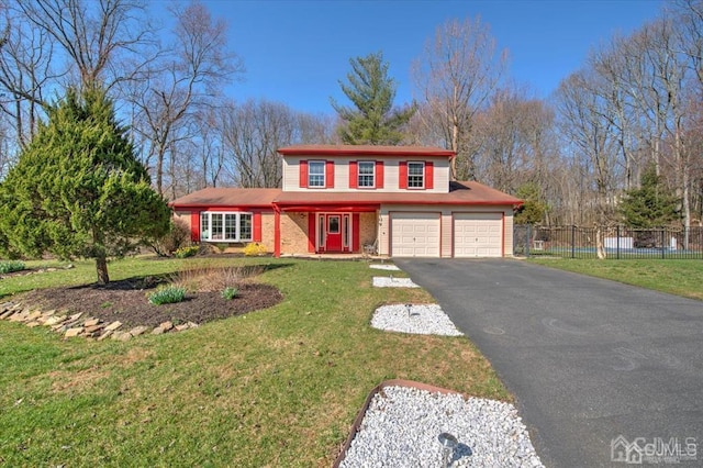 view of front of property with a garage and a front lawn