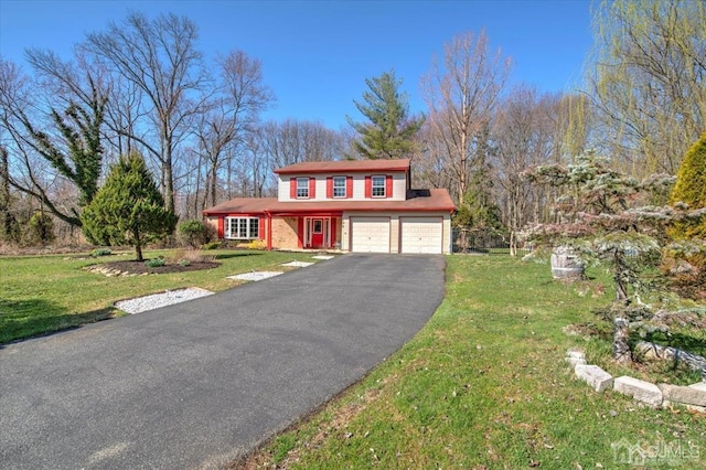 front of property with a garage and a front lawn