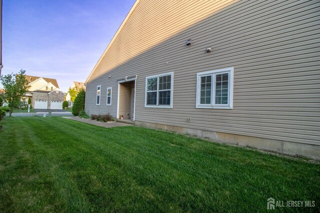 rear view of property featuring a yard
