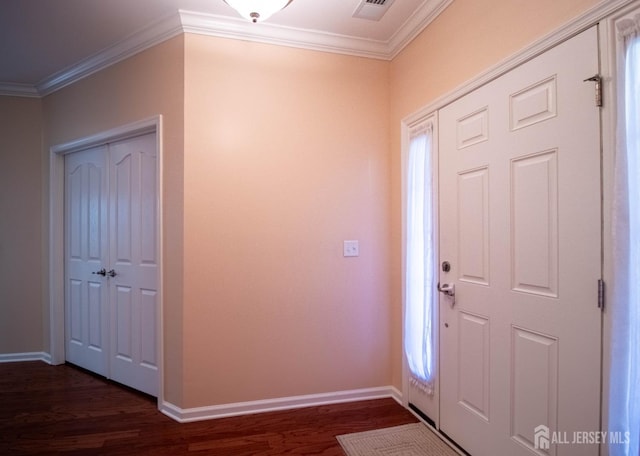 entryway with dark wood-style flooring, crown molding, and baseboards