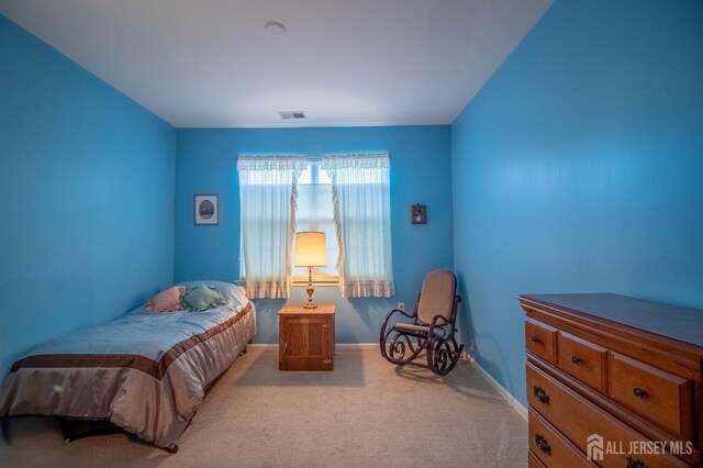 carpeted bedroom featuring baseboards