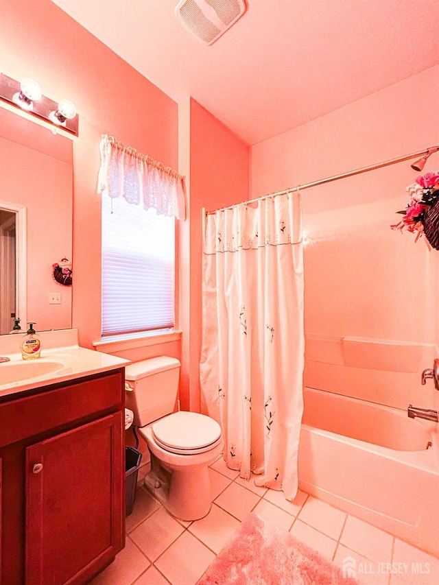 full bath featuring toilet, tile patterned floors, vanity, and shower / bath combo with shower curtain