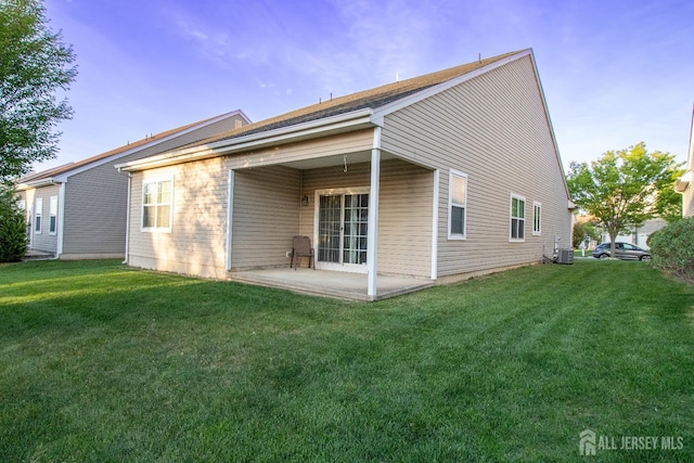 back of property featuring a patio, a lawn, and cooling unit