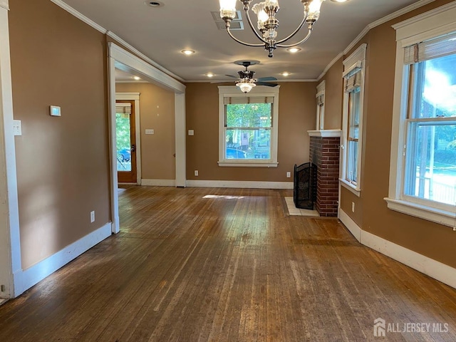 unfurnished living room featuring a brick fireplace, wood finished floors, baseboards, and ornamental molding