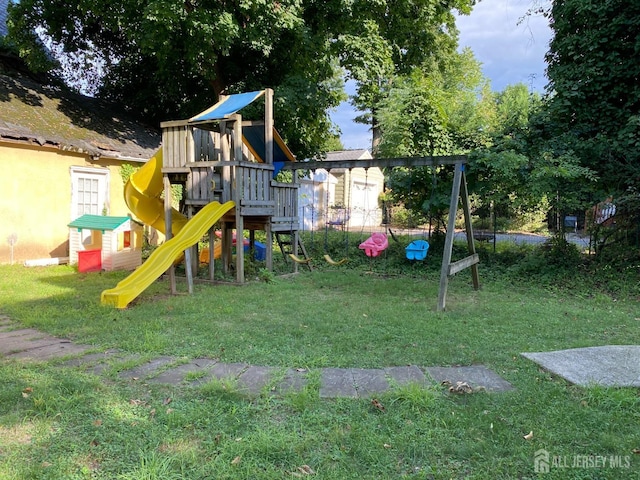 view of playground with a lawn