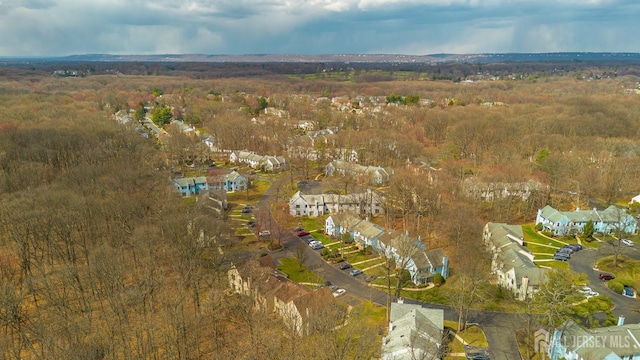 drone / aerial view with a forest view and a residential view