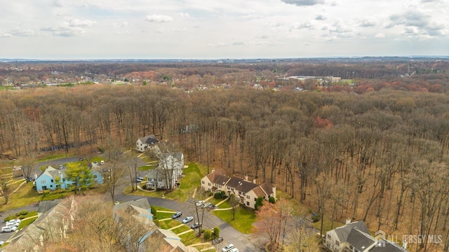 drone / aerial view featuring a forest view