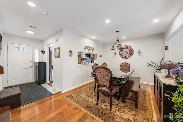 dining space with baseboards, light wood-style floors, visible vents, and recessed lighting