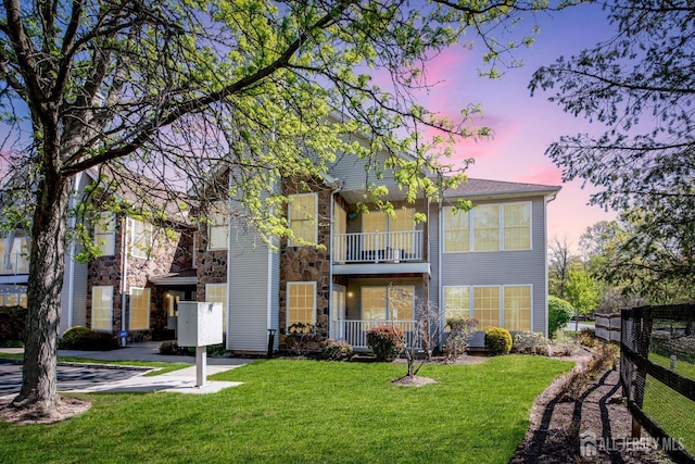 1 Lackland Ave, Piscataway, NJ 08854 - view of front of property featuring stone siding, a balcony, and a lawn