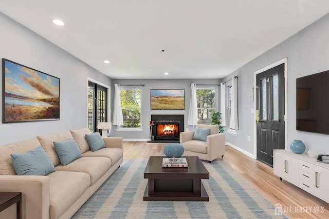 1 Lackland Ave, Piscataway, NJ 08854 - living area featuring light wood finished floors, healthy amount of natural light, recessed lighting, and a lit fireplace