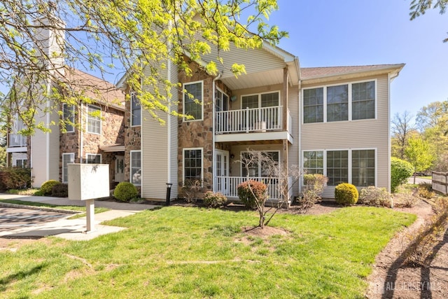 1 Lackland Ave, Piscataway, NJ 08854 - back of house with a balcony, a lawn, and stone siding