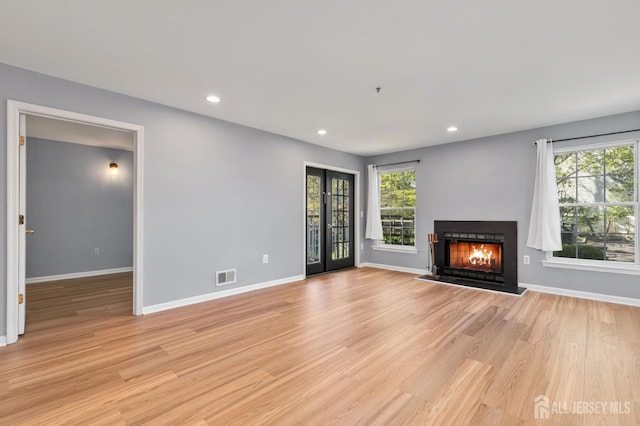 1 Lackland Ave, Piscataway, NJ 08854 - unfurnished living room featuring healthy amount of natural light, light wood-type flooring, a warm lit fireplace, and recessed lighting