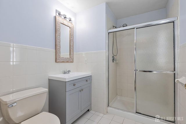 1 Lackland Ave, Piscataway, NJ 08854 - bathroom with tile walls, a shower stall, vanity, tile patterned floors, and wainscoting