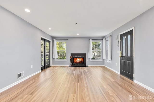 1 Lackland Ave, Piscataway, NJ 08854 - unfurnished living room featuring light wood finished floors, a warm lit fireplace, and recessed lighting
