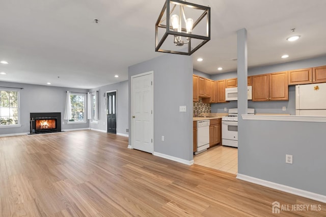 1 Lackland Ave, Piscataway, NJ 08854 - kitchen featuring white appliances, light wood finished floors, recessed lighting, light countertops, and a glass covered fireplace