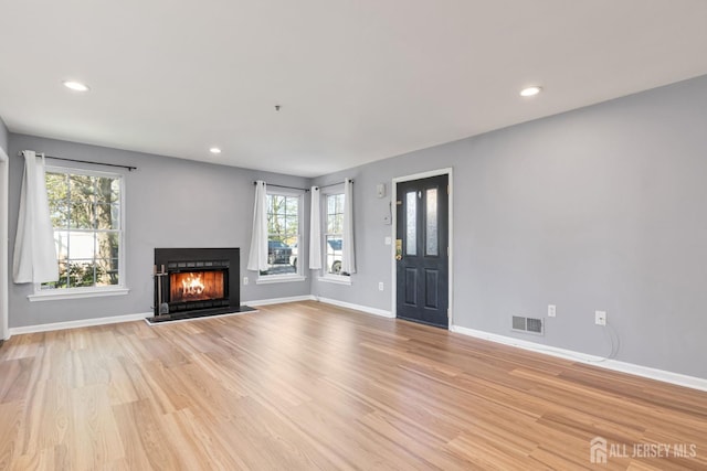 1 Lackland Ave, Piscataway, NJ 08854 - unfurnished living room with light wood finished floors, healthy amount of natural light, a warm lit fireplace, and recessed lighting