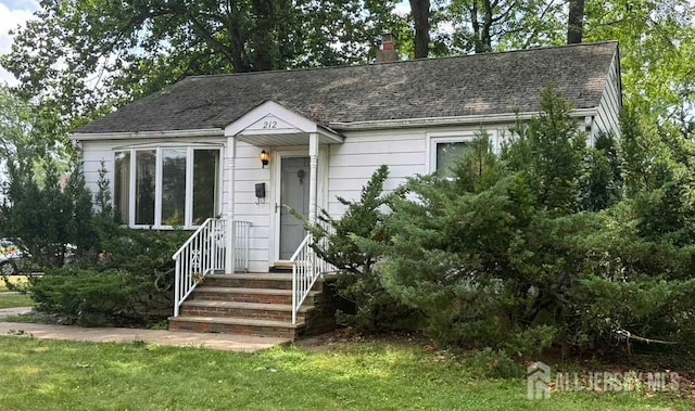 212 Middlesex Ave, Iselin, NJ 08830 - view of front of property featuring a chimney, a front yard, and roof with shingles