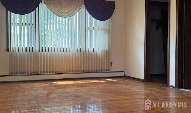 212 Middlesex Ave, Iselin, NJ 08830 - unfurnished room with baseboard heating and wood finished floors