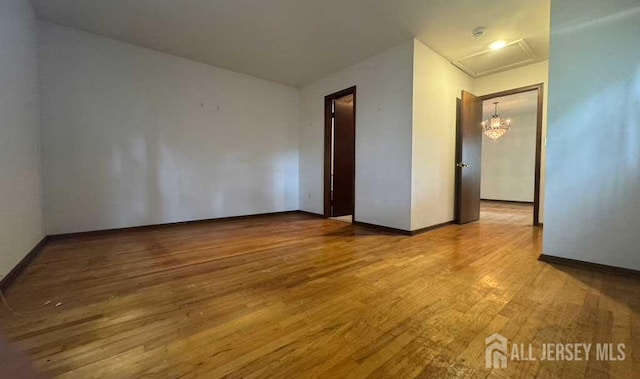 212 Middlesex Ave, Iselin, NJ 08830 - empty room featuring wood finished floors and a chandelier