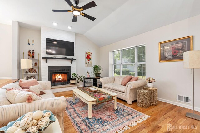 183 Driscoll Ct, Franklin Twsp, NJ 08873 - living area with a ceiling fan, lofted ceiling, light wood finished floors, and a large fireplace