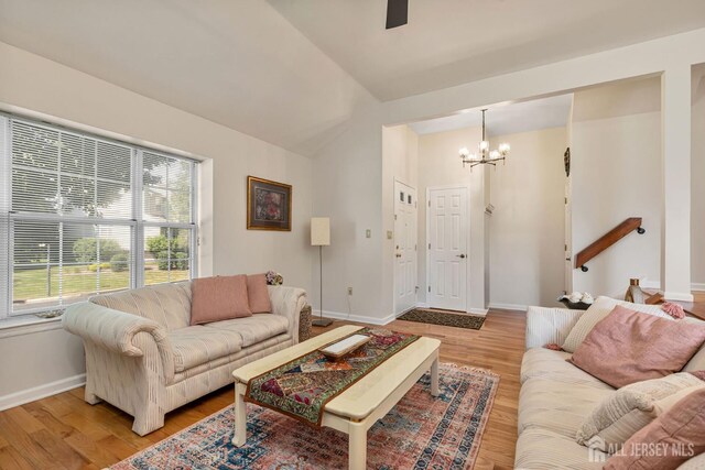 183 Driscoll Ct, Franklin Twsp, NJ 08873 - living area with a chandelier, lofted ceiling, light wood-style floors, and ceiling fan
