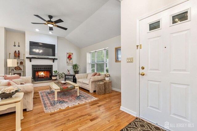 183 Driscoll Ct, Franklin Twsp, NJ 08873 - living area with light wood-type flooring, a ceiling fan, lofted ceiling, a large fireplace, and recessed lighting