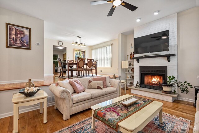 183 Driscoll Ct, Franklin Twsp, NJ 08873 - living area featuring ceiling fan, light wood finished floors, and a fireplace