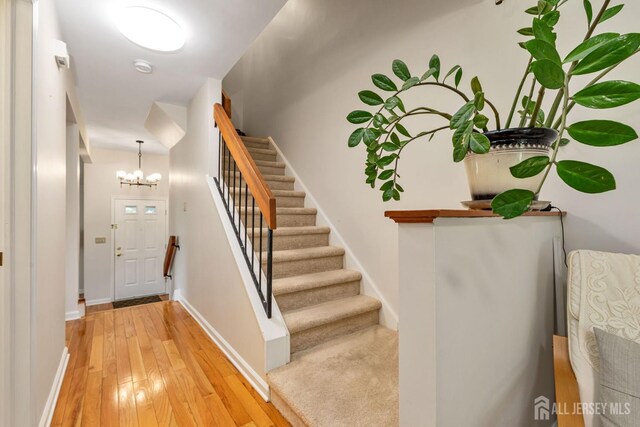 183 Driscoll Ct, Franklin Twsp, NJ 08873 - stairway featuring a chandelier and wood-type flooring