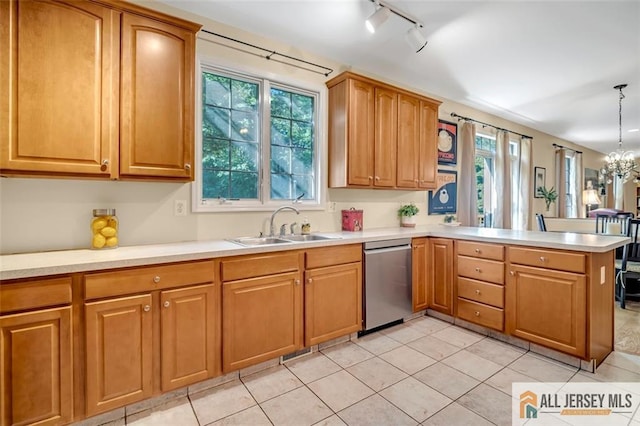 2 Danser Dr, Cranbury, NJ 08512 - kitchen with stainless steel dishwasher, a peninsula, light countertops, light tile patterned floors, and track lighting