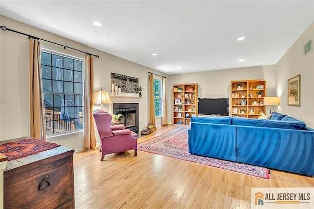 2 Danser Dr, Cranbury, NJ 08512 - living area with wood finished floors, a fireplace with flush hearth, and recessed lighting