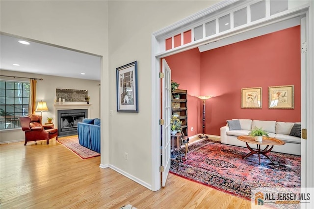 2 Danser Dr, Cranbury, NJ 08512 - living area featuring wood finished floors, a fireplace with flush hearth, recessed lighting, and a high ceiling