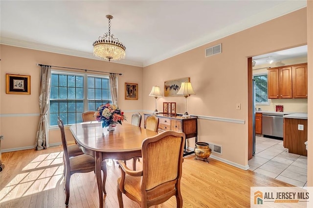 2 Danser Dr, Cranbury, NJ 08512 - dining area featuring healthy amount of natural light, light wood-style flooring, a chandelier, and ornamental molding