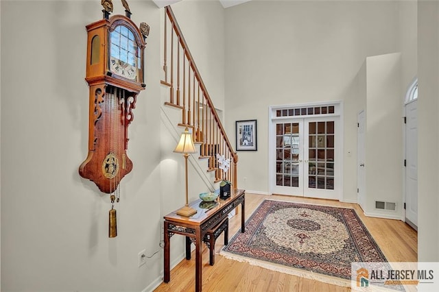 2 Danser Dr, Cranbury, NJ 08512 - entrance foyer with french doors, a high ceiling, stairway, and wood finished floors