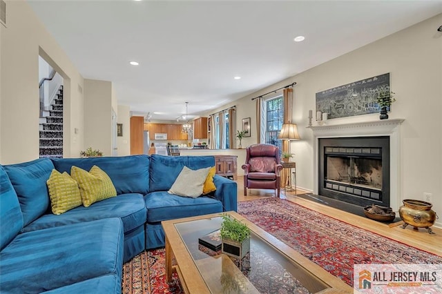 2 Danser Dr, Cranbury, NJ 08512 - living room with recessed lighting, wood finished floors, stairway, and a fireplace