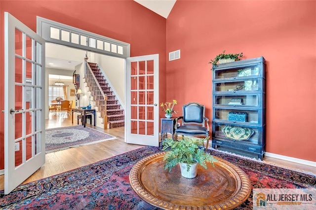 2 Danser Dr, Cranbury, NJ 08512 - entryway featuring french doors, wood finished floors, high vaulted ceiling, and stairway
