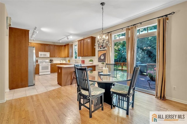 2 Danser Dr, Cranbury, NJ 08512 - dining room with light wood finished floors, a chandelier, and rail lighting