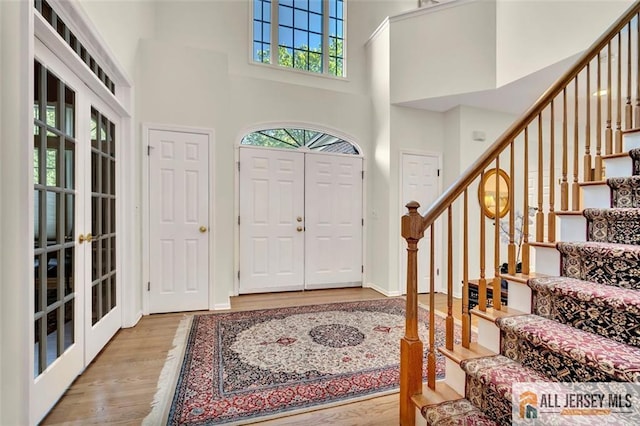 2 Danser Dr, Cranbury, NJ 08512 - entrance foyer featuring a towering ceiling, wood finished floors, stairs, and french doors