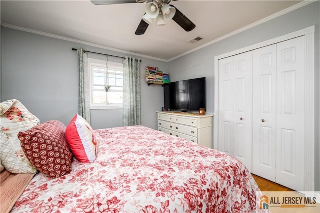 7 Hollywood St, South River, NJ 08882 - bedroom with ornamental molding, a closet, wood finished floors, and a ceiling fan