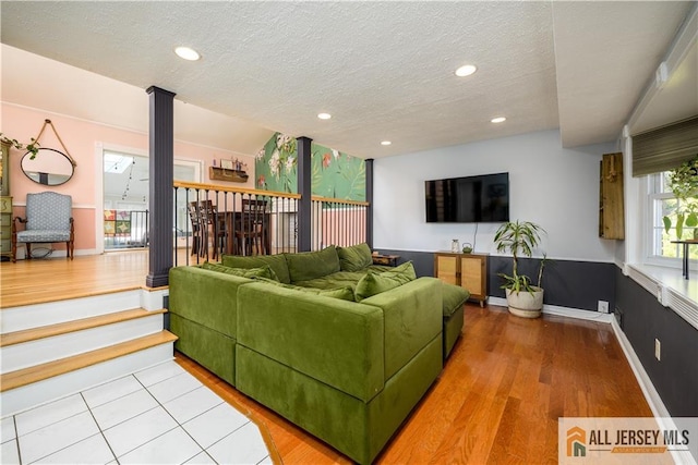 7 Hollywood St, South River, NJ 08882 - living room with light wood-type flooring, a textured ceiling, ornate columns, and recessed lighting