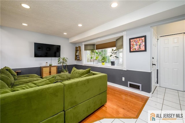 7 Hollywood St, South River, NJ 08882 - living room with recessed lighting, light tile patterned flooring, and a textured ceiling