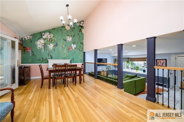 7 Hollywood St, South River, NJ 08882 - dining space featuring decorative columns, wood finished floors, vaulted ceiling, and a chandelier