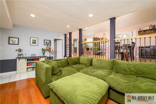 7 Hollywood St, South River, NJ 08882 - living room with ornate columns, a textured ceiling, recessed lighting, and light wood-type flooring