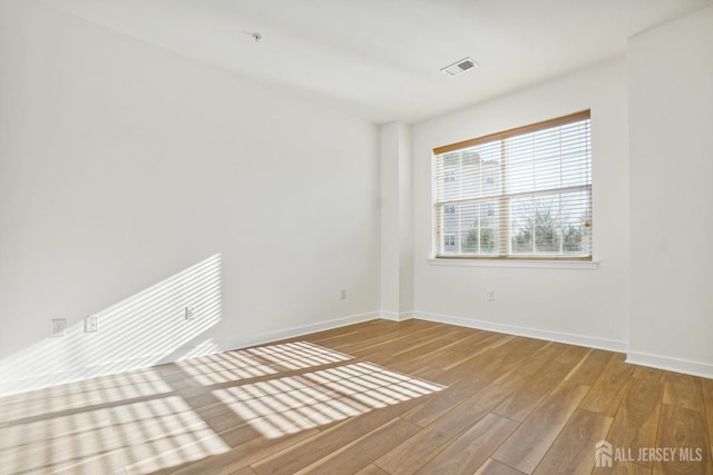 empty room with hardwood / wood-style floors