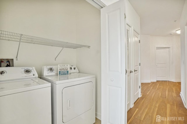 laundry room featuring light hardwood / wood-style flooring and independent washer and dryer