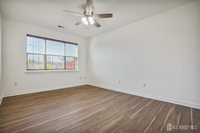 empty room featuring dark hardwood / wood-style flooring and ceiling fan