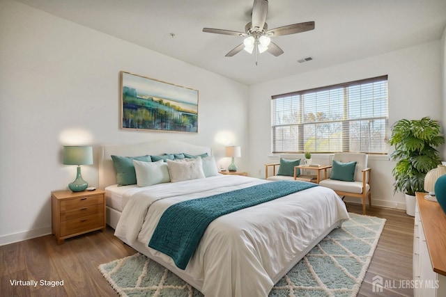 bedroom featuring dark hardwood / wood-style flooring and ceiling fan