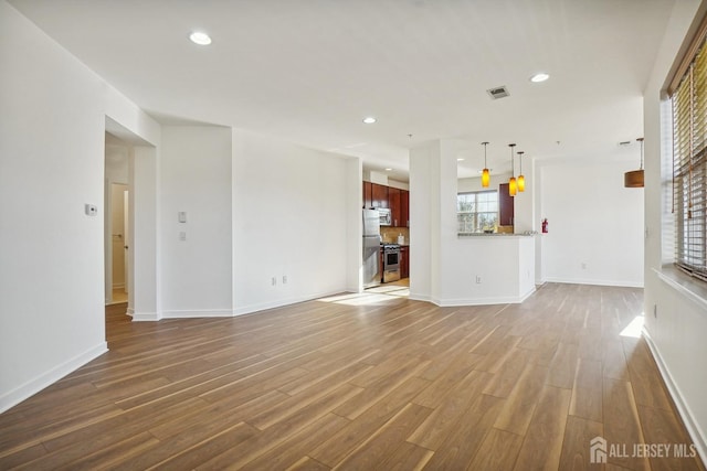 unfurnished living room featuring wood-type flooring