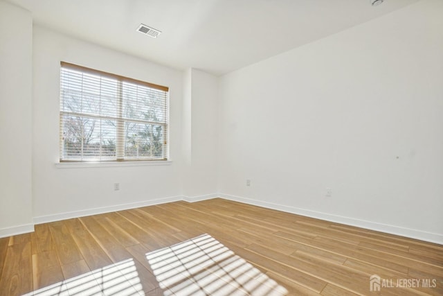 spare room featuring hardwood / wood-style floors