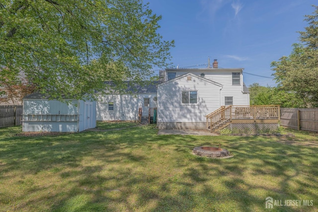 7 Winslow Ave, East Brunswick, NJ 08816 - fenced backyard featuring a fire pit, a deck, and a storage shed
