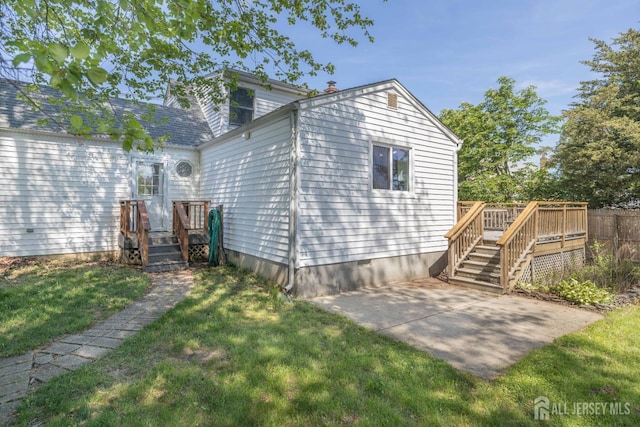 7 Winslow Ave, East Brunswick, NJ 08816 - rear view of property featuring a lawn, a patio area, and a deck